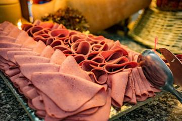 Sausage cut into slices on a tray. A beautiful dish of sausage.