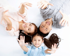 Top view of Happy asian Family lying on the floor