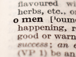 Obraz premium Dictionary definition of word omen, selective focus.