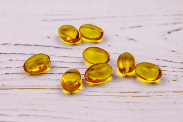 Omega 3 pills on a white wooden table