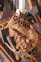 Cocoa powder and a bar of dark chocolate