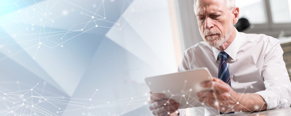 Portrait of senior businessman working on tablet; multiple exposure