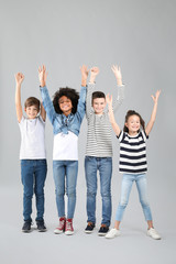 Obraz premium Happy children in jeans on grey background