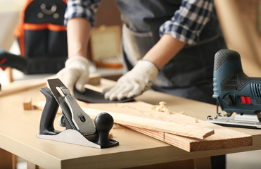 Female carpenter working in shop