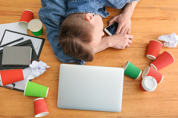 Tired overworked man sleeping at table