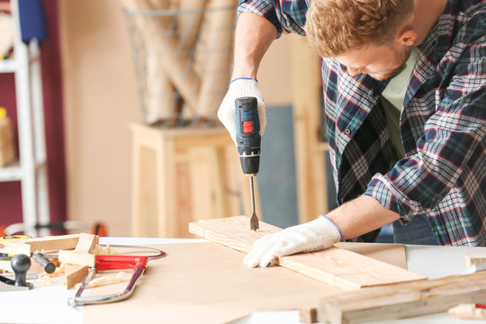 Male carpenter working in shop
