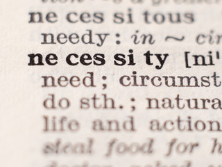 Obraz premium Dictionary definition of word necessity, selective focus.