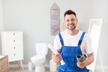 Portrait of handsome plumber in restroom