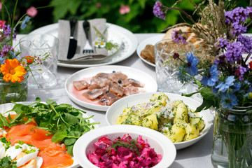 Scandinavian midsummer feast with potato salad, herring, salmon and beetroot - obrazy, fototapety, plakaty