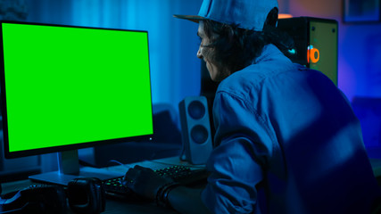 Professional Gamer Playing Online Video Game on His Powerful Personal Computer with Colorful Neon...
