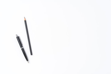 Black pen and pencil on white background with copyspace
