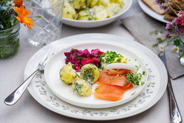 Scandinavian midsummer feast with potato salad,  salmon and beetroot