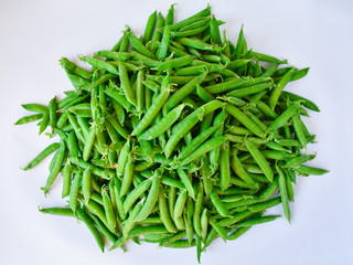 Green peas in bills on a white background. Vegetarian. Proper nutrition.