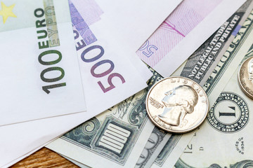 Pack of US dollars and euro banknotes and coins background finance economy currency close up selective focus