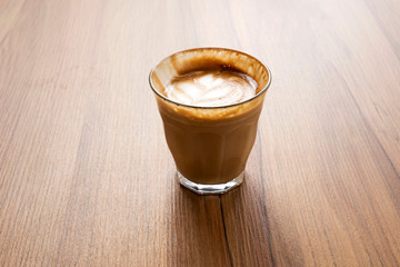 Hot latte on a wooden table