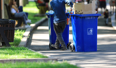 worker cleans garbage in the park