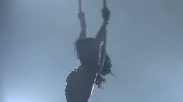 Young girl performs the acrobatic elements in the air ring. Slow motion. Closeup. 204