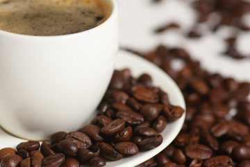 White Cup Of Coffee And Coffee Beans