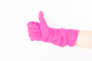 Close up of female hand in pink protective rubber glove showing thumbs up sign against white background