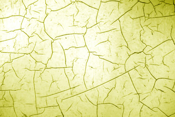 Cracked paint texture in yellow color.