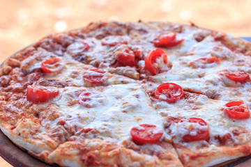 Whole pizza Margarita with tomatoes and cheese. Food on the beach