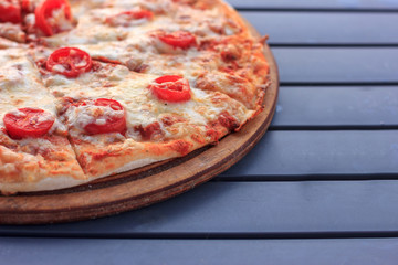 Whole pizza Margarita with tomatoes and cheese. Food on the beach