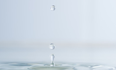 Splash from a drop of water on a light background macro