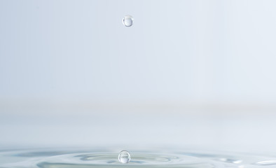 Splash from a drop of water on a light background macro