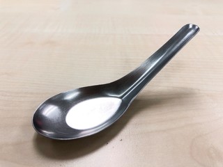 Stainless steel curry spoon on the table