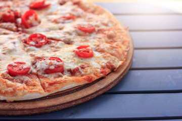 Whole pizza Margarita with tomatoes and cheese. Food on the beach