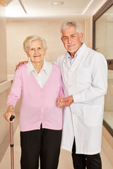 Chief doctor takes care of old woman with crutch