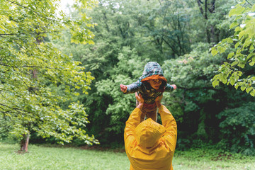 Father and son having a great time in a rainy day	