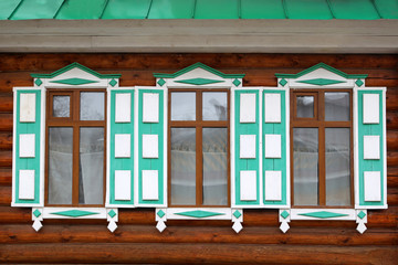Wooden windows with decorative shutters.