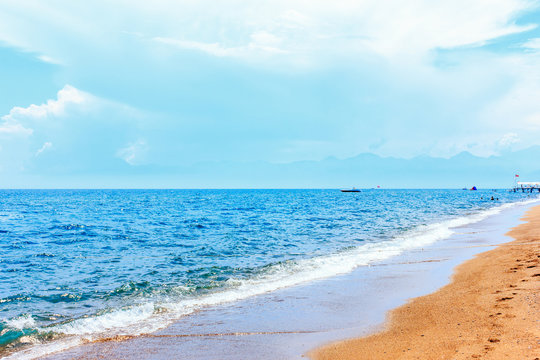 Calm blue mediterranean sea and yellow sand