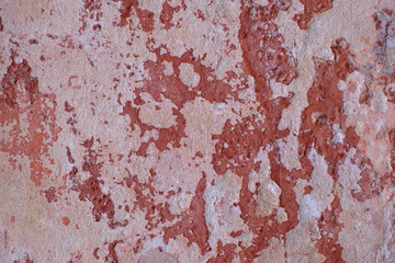 Red paint peeled of the wall