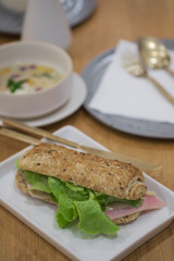 Delicious ham and cheese sandwich on white plate