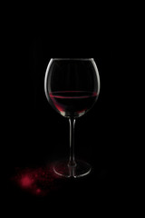 A glass of red wine with some red blood.