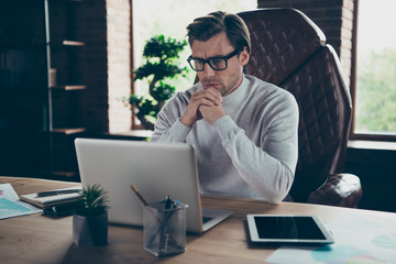 Portrait of his he attractive intellectual leader partner financier economist analyst lawyer economist reading presentation report at industrial loft wooden brick style interior work place station