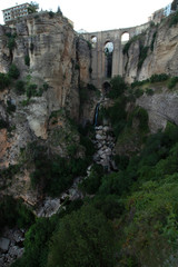 View of the New Bridge, the cliffs from the side of the gorge in the early morning Ronda, Andalusia, Spain