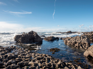 Rainbow over Atlantic ocean. Rocky stone coastline. Burren national park. Ireland.