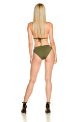 Back view of pretty young lady in green bikini swimsuit and sandals on white background