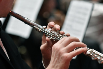 Close up tight shot of hand playing flute