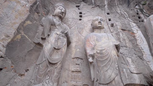 The Longmen Grottoes . Broken Buddha and the stone caves and sculptures in the Longmen Grottoes in Luoyang, China.