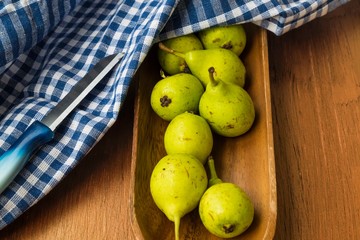 fresh pears in a basket on wooden table