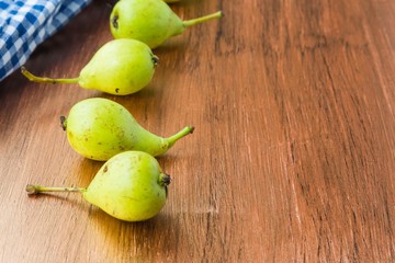 fresh pears in a basket on wooden table