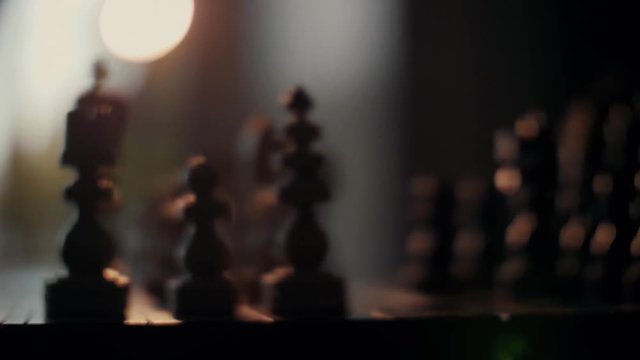 Chess - two black moves. Black takes Pleasant atmosphere, warm contre-jour light, live game.white bishop and black move the knight.  50 fps