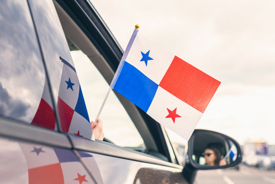 Woman or Girl Holding Panama Flag from the open car window. Concept