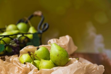 fresh pears in a basket on wooden table