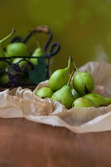 fresh pears in a basket on wooden table