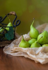 fresh pears in a basket on wooden table